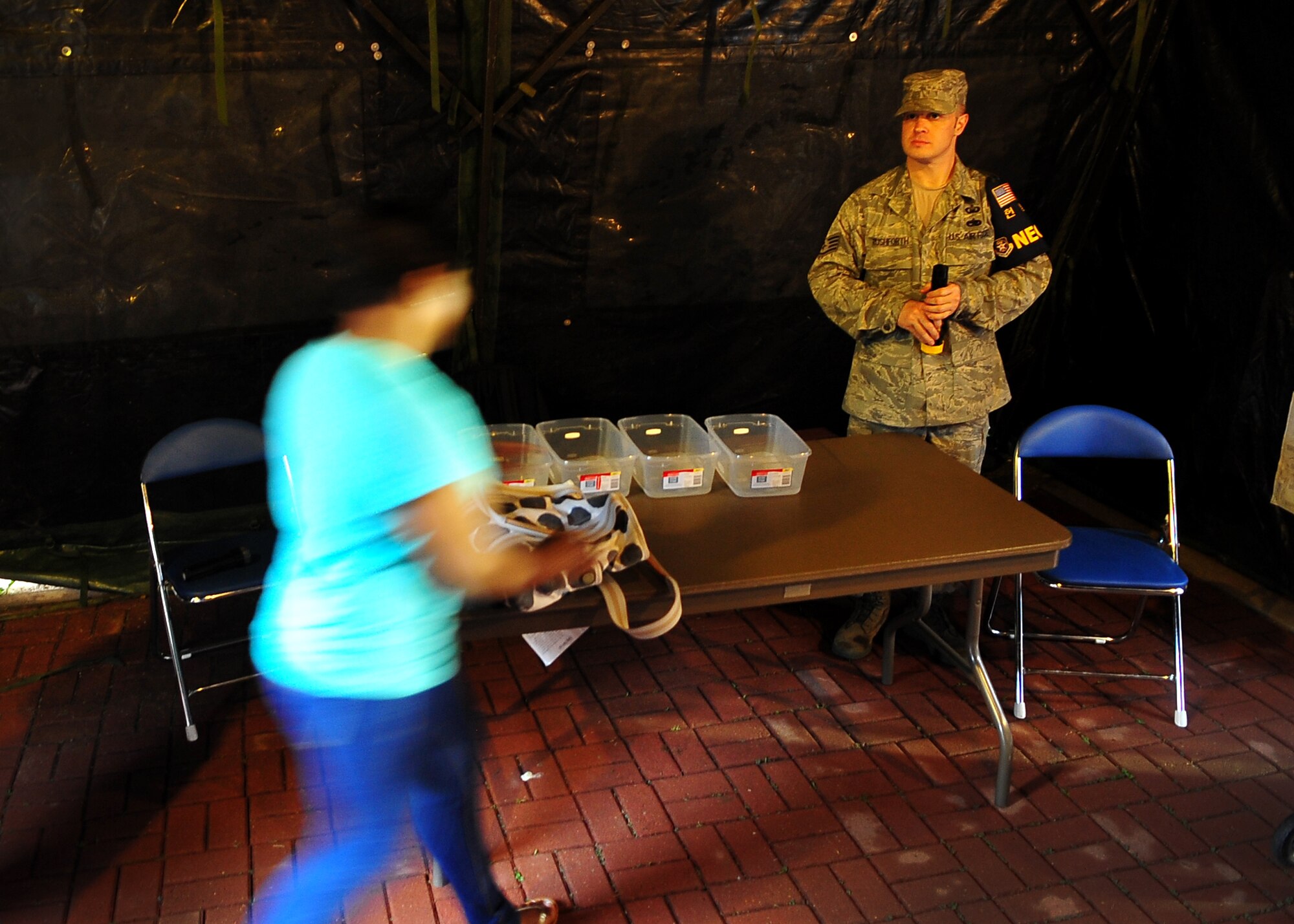U.S. Army and Air Force personnel prepare to process dependents, non-emergency essential civilians and contractors May 20. Individuals are participating in the Courageous Channel exersice which is held every spring to train servicemembers on registration and evacuation processes. (U.S. Air Force photo/Senior Airman Evelyn Chavez)
