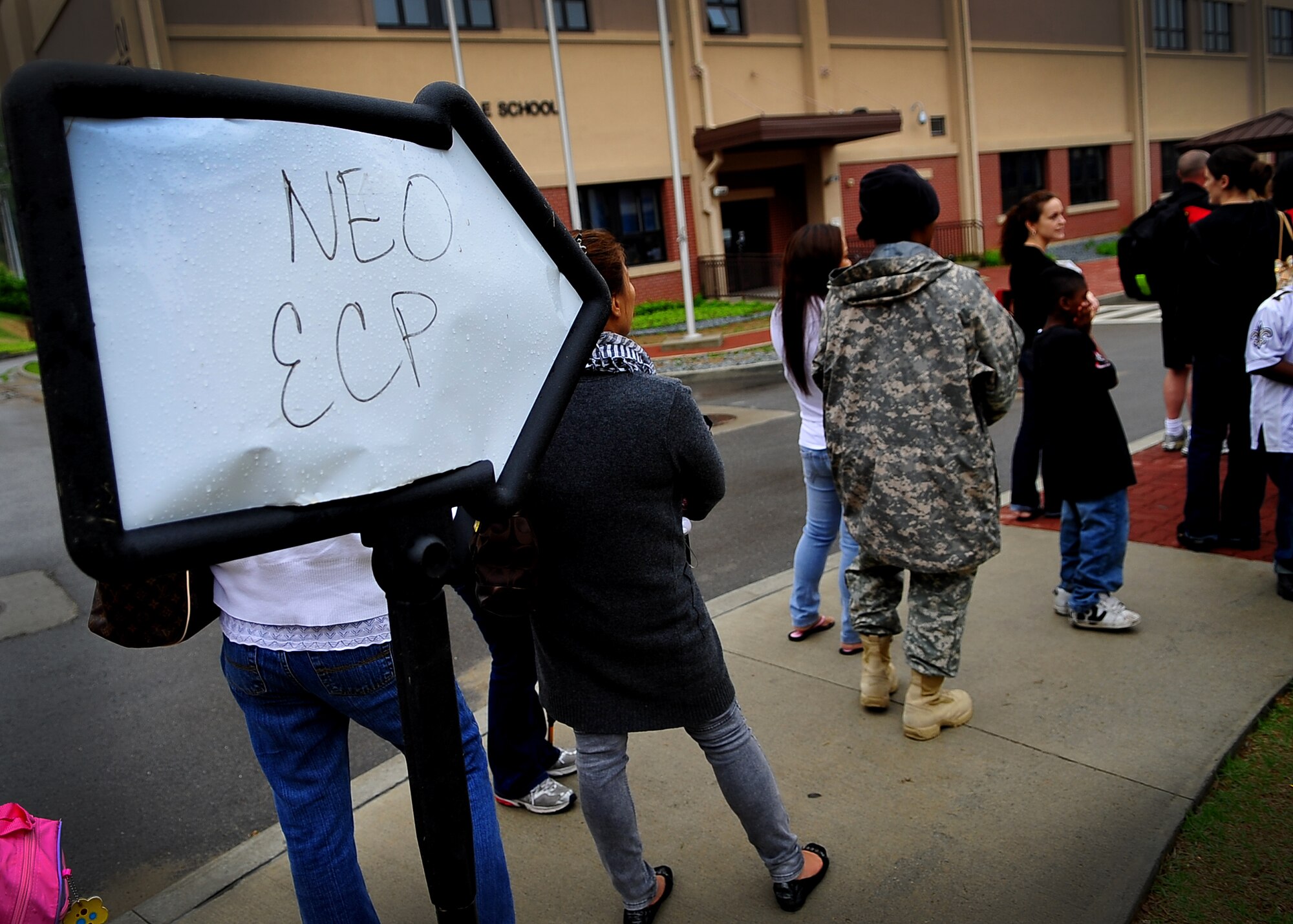 U.S. military dependents, non-emergency essential civilians and contractors walk through a processing line at Osan American High School.  These individuals are participating in the Courageous Channel exercise which is held every spring to train servicemembers on registration and evacuation processes. (U.S. Air Force photo/Senior Airman Evelyn Chavez)
