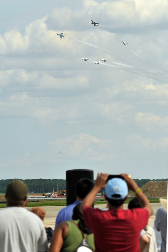 The Thunderbirds perform for a crowd of approximately 100,000 people during the 2011 Joint Service Open House here May 21. The JSOH affords the public an opportunity to meet the men and women of the Armed Forces and to see military equipment through the efforts of active duty guard and reserve service members, as well as civilians employees, retirees and family members. (U.S. Air Force photo by Senior Airman Perry Aston) (Released)