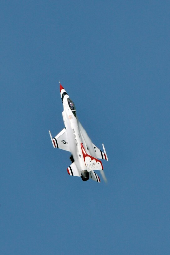 A Thunderbird jet accelerates toward the sky during the 2011 Joint Service Open House here May 21. The JSOH affords the public an opportunity to meet the men and women of the Armed Forces and to see military equipment through the efforts of active duty, guard and reserve servicemembers, as well as civilians employees, retirees and family members. (U.S. Air Force photo by Senior Airman Perry Aston) 