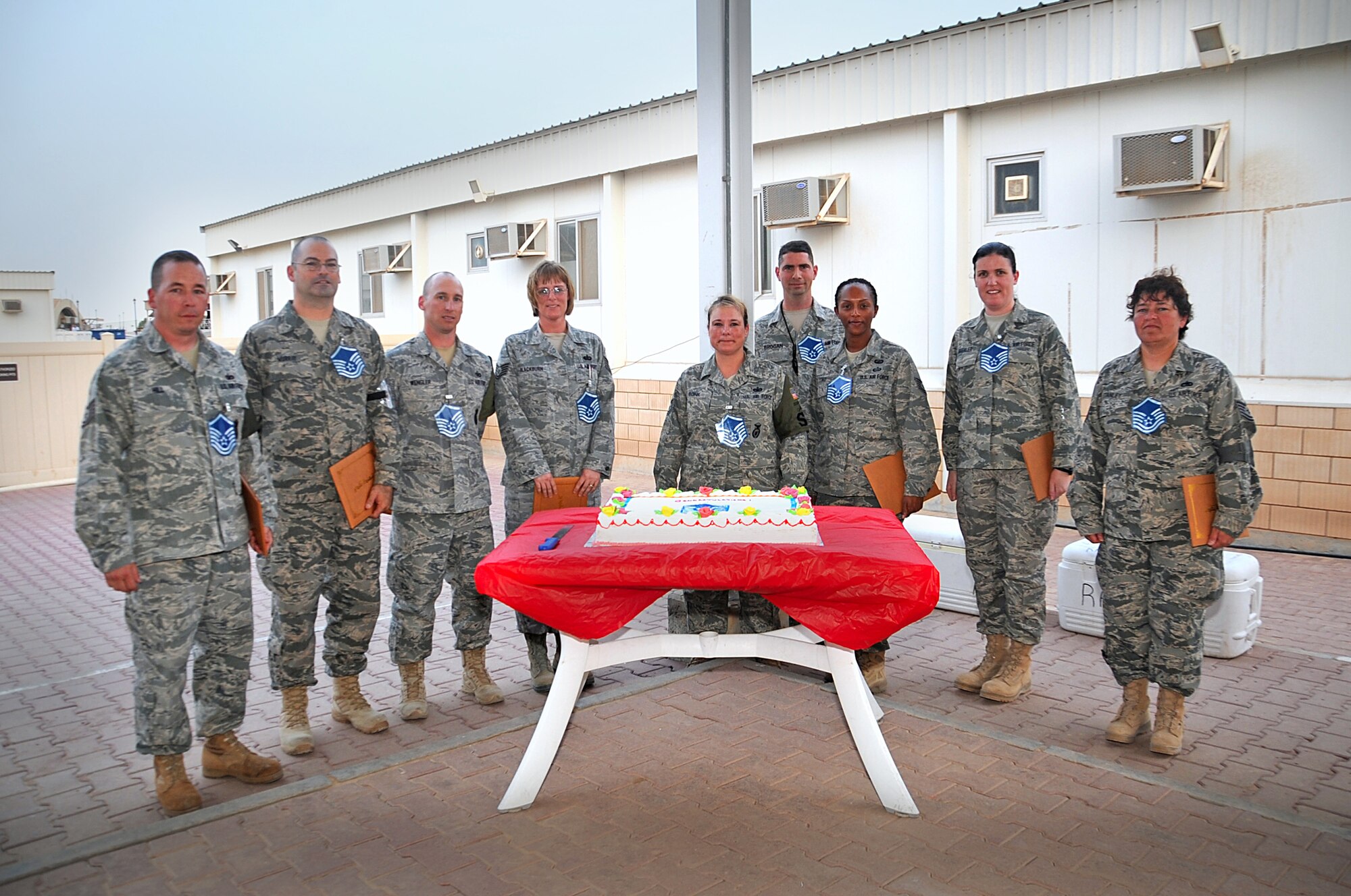 Nine newly selected master sergeants celebrate their achievement during their deployment to the 386th Air Expeditionary Wing. (U.S. Air Force photo by Senior Airmen Cynthia Spalding)