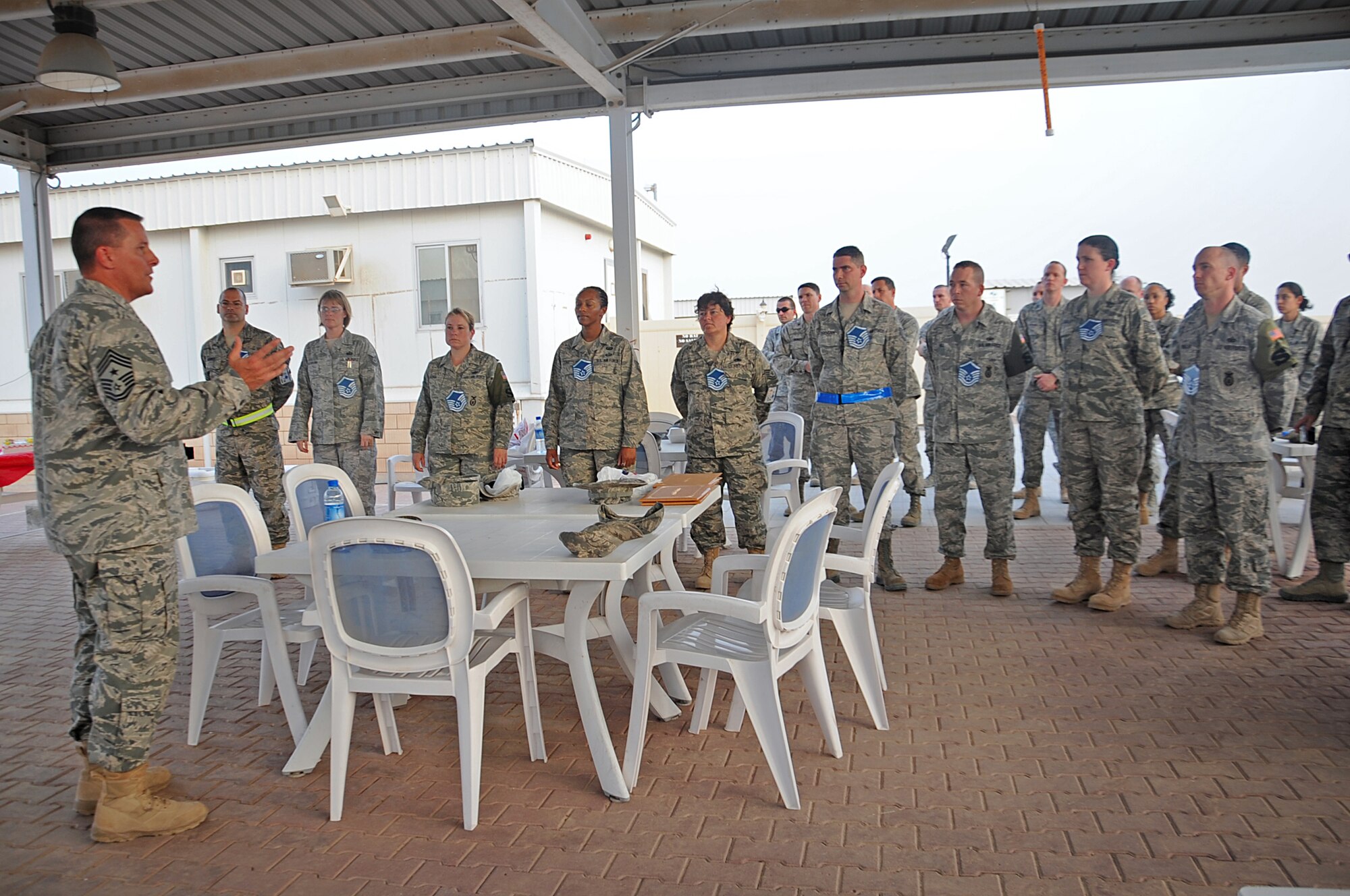 Command Chief Master Sgt. Richard Turcotte, 386th Air Expeditionary Wing command chief, congratulates newly selected master sergeants May 20. The E-7 selectees are currently deployed to the 386th AEW. (U.S. Air Force photo by Senior Airmen Cynthia Spalding)
