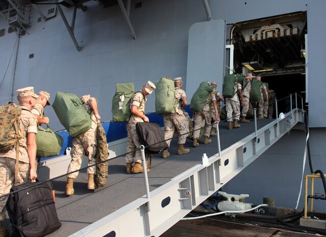 Marines and sailors with the 24th Marine Expeditionary Unit board the USS Iwo Jima (LHD-7) at Pier 10, May 22, 2011. The Marines and sailors on the ship are preparing to travel to participate in New York City's Fleet Week. Various units from II Marine Expeditionary Force and Marines Forces Reserve have organized under the 24th MEU to form the Special Purpose Marine Air Ground Task Force - New York. The Marines are embarking on the Navy’s Amphibious Assault Ships, the USS Iwo Jima (LHD -7) and USS New York (LPD-21) to take part in New York City's Fleet Week from May 25 to June 1, 2011. There, the Marines will showcase the capabilities of the MAGTF, and also honor those who have served by participating in a various of events during the Memorial Day weekend.
