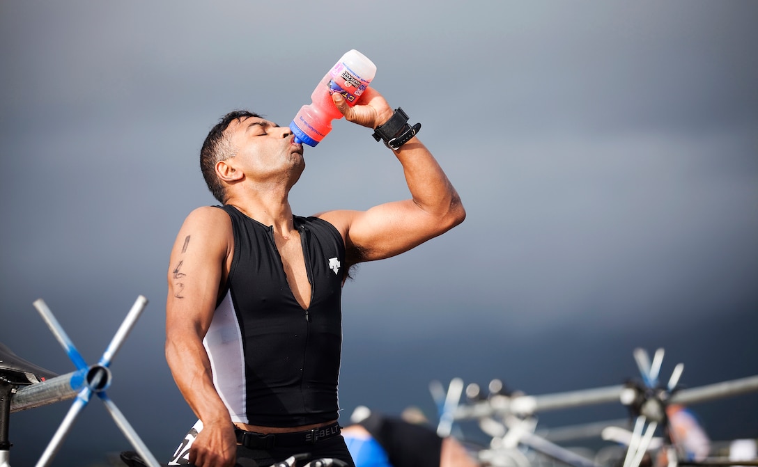 Amit Bhavsar guzzles electrolytes in between completing the 500-meter swim and 11.1-mile bicycle portions of the 2011 Sprint Triathlon outside Hangar 101 on Marine Corps Base Hawaii, May 22, 2011. Bhavsar was among approximately 225 service members and local community members who gathered under a chilly, gray sky to participate in the triathlon. The event was hosted by Headquarters Battalion and Marine Corps Community Services Semper Fit division.