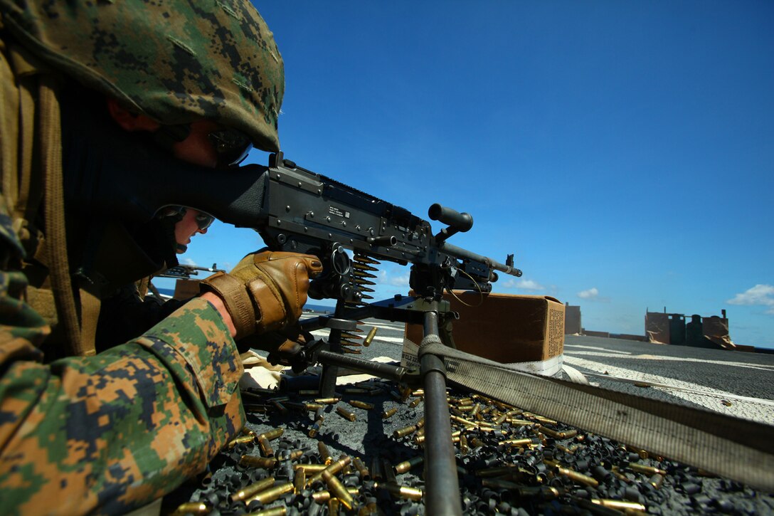 Lance Cpl. Raymond Cruz, machine-gunner, Weapons Platoon, Landing Force Company, fires an M-240B machine gun during a machine gun drill May 23 aboard the amphibious transport dock ship USS Tortuga (LSD 46). The Marines conducted the shoot to keep up their qualifications as well as to prepare them for upcoming training during Cooperation Afloat Readiness and Training (CARAT) 2011. CARAT is a series of bilateral exercises held between U.S. and Southeast Asian defense forces with the goals of enhancing regional cooperation, promoting mutual trust and understanding, and increasing operational readiness. The majority of the Marines comprising the landing force are volunteers from 2nd Battalion, 23rd Marine Regiment, 4th Marine Division and 4th Assault Amphibian Battalion, 4th Marine Division. Reserve Marines are an integral element of the Marine Corps total force and regularly participate in operations and theater security cooperation exercises overseas. (U.S. Marine Corps Photo by Cpl. Aaron Hostutler)
