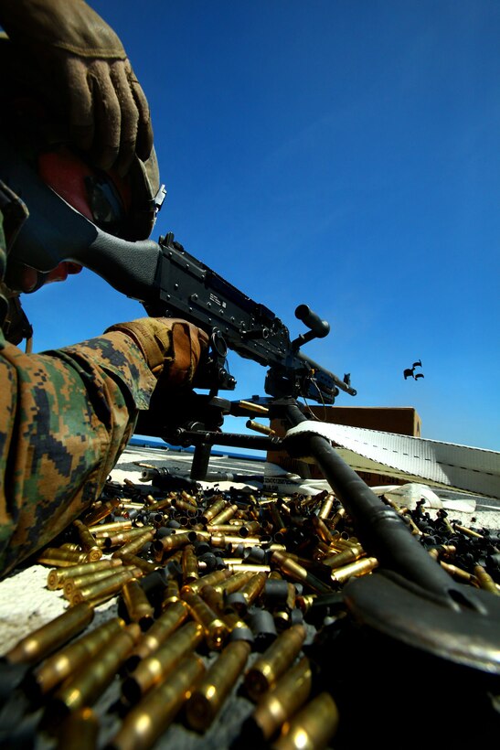 Lance Cpl. Antonio Landaverde, machine-gunner, Weapons Platoon, Landing Force Company, fires the M-240B machine gun during a live-fire drill May 23 aboard the amphibious transport dock ship USS Tortuga (LSD 46). The Marines with LF Company are participating in Cooperation Afloat Readiness and Training (CARAT) 2011. CARAT is a series of bilateral exercises held between U.S. and Southeast Asian defense forces with the goals of enhancing regional cooperation, promoting mutual trust and understanding, and increasing operational readiness. The majority of the Marines comprising the landing force are volunteers from 2nd Battalion, 23rd Marine Regiment, 4th Marine Division and 4th Assault Amphibian Battalion, 4th Marine Division. Reserve Marines are an integral element of the Marine Corps total force and regularly participate in operations and theater security cooperation exercises overseas. (U.S. Marine Corps Photo by Cpl. Aaron Hostutler)