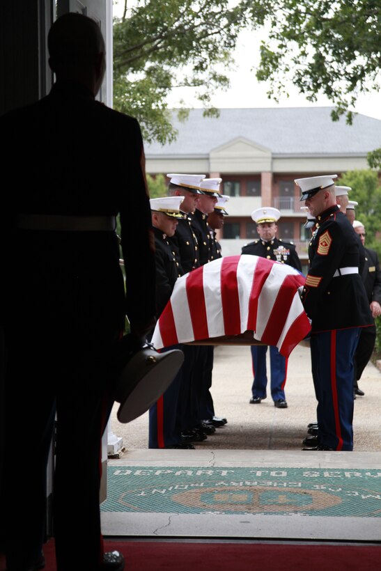 Pallbearers bring the coffin of Lt. Col. Benjamin J. Palmer into the Marine Corps Air Station Cherry Point Chapel May 23. More than 500 members of the local and military communities gathered to bid farewell to the beloved Marine who was killed in action in Helmand province, Afghanistan, May 12 while supporting Operation Enduring Freedom.