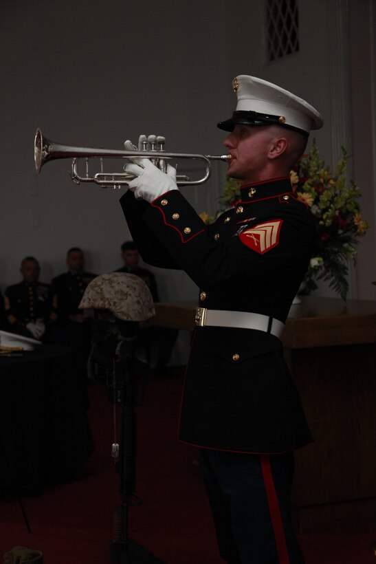 Sgt. Michael A. Winterstein, a musician with the 2nd Marine Aircraft Wing Band, plays “Taps” on his trumpet at the memorial service for Lt. Col. Benjamin J. Palmer at the Marine Corps Air Station Cherry Point chapel May 23.