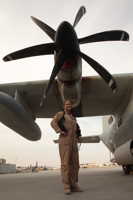 Lt. Cmdr. Amber Biles, the 2nd Marine Aircraft Wing (Forward) aeromedical safety officer, stands beneath the propeller of a KC-130J Hercules on the flight of Kandahar Airfield in Kandahar province, Afghanistan. An aerospace physiologist by trade, Biles is responsible for the proper utilization of flight equipment by the pilots of 2nd MAW (Fwd.). "It's all about human performance, anything that affects the pilot in the aircraft," said Biles. "We look at ways that both enhance performance and things that are detrimental to performance, and how we can negate those detriments."::r::::n::