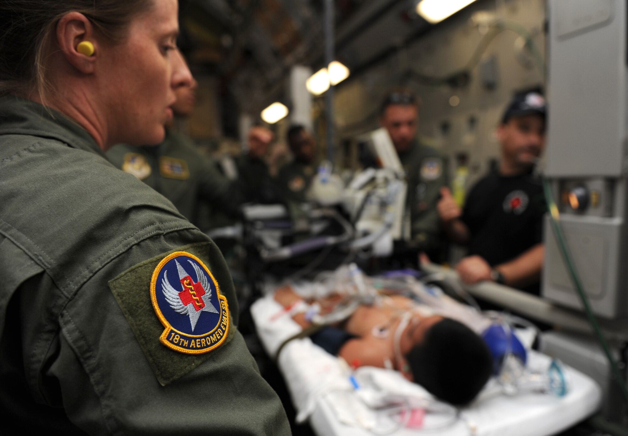 Master Sgt. Molly Quentin, aeromedical evacuation technician with the 18th Aeromedical Evacuation Squadron, makes preparations to transport a critically ill patient on a medical evacuation mission from Pago Pago, American Samoa to Tripler Army Medical Center, Hawaii May 22. (U.S. Air Force photo/Senior Airman Lauren Main)