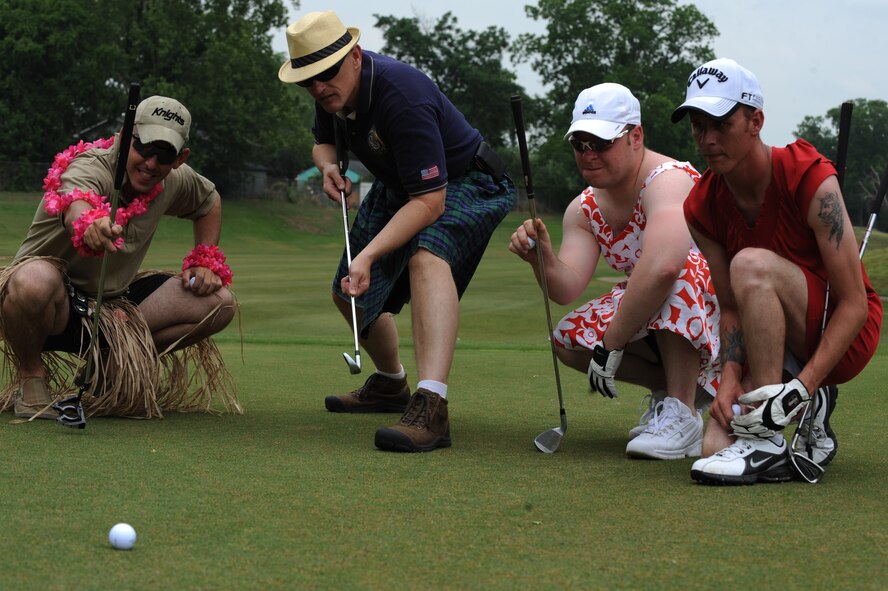 Members of the 2nd Security Forces Squadron pose for a photo at the Fox Run Golf Course on Barksdale Air Force Base, La., May 20. Participants who wore skirts were given a distance advantage. The Airmen and civilian workers of the 2 SFS gathered to celebrate National Police Week, enacted by President Kennedy in 1962, to honor all law enforcement officers lost in the line of duty. (U.S. Air Force photo/Airman 1st Class Micaiah Anthony)(RELEASED)