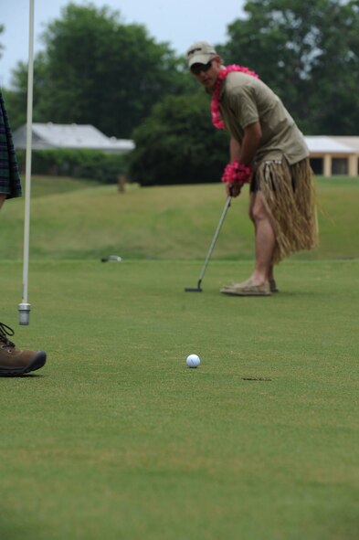 Capt. Daniel Minnocci, 2nd Security Forces Squadron, putts a golf ball at the Fox Run Golf Course on Barksdale Air Force Base, La., May 20. Participants who wore skirts were given a distance advantage. The Airmen and civilian workers of the 2 SFS gathered to celebrate National Police Week, enacted by President Kennedy in 1962, to honor all law enforcement officers lost in the line of duty. (U.S. Air Force photo/Airman 1st Class Micaiah Anthony)(RELEASED)