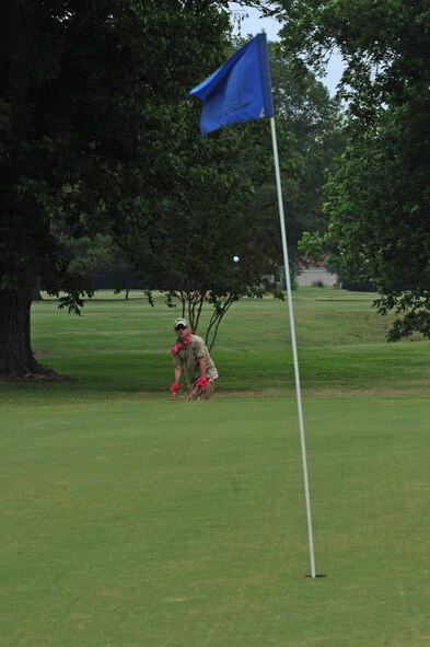 Capt. Daniel Minnocci hits a golf ball onto the green at the Fox Run Golf Course on Barksdale Air Force Base, La., May 20. Participants who wore skirts were given a distance advantage. The Airmen and civilian workers of the 2 SFS gathered to celebrate National Police Week, enacted by President Kennedy in 1962, to honor all law enforcement officers lost in the line of duty. (U.S. Air Force photo/Airman 1st Class Micaiah Anthony)(RELEASED)