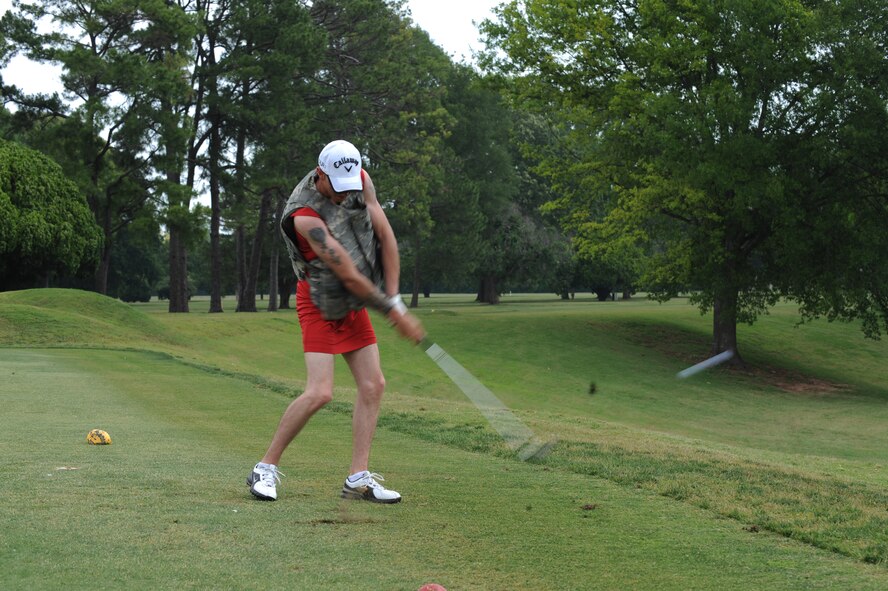 Staff Sgt. Mattew Jones, 2nd Security Forces Squadron, drives a golf ball at the Fox Run Golf Course on Barksdale Air Force Base, La., May 20. Participants who wore skirts were given a distance advantage. The Airmen and civilian workers of the 2 SFS gathered to celebrate National Police Week, enacted by President Kennedy in 1962, to honor all law enforcement officers lost in the line of duty. (U.S. Air Force photo/Airman 1st Class Micaiah Anthony)(RELEASED)