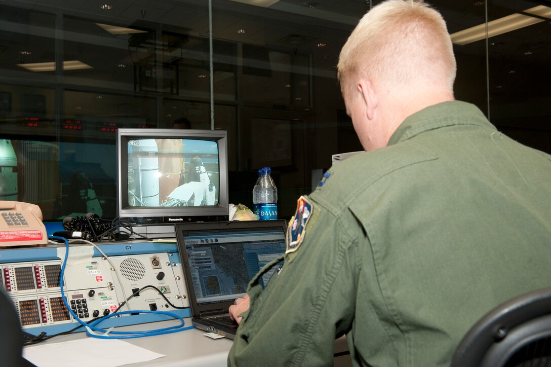 Capt. Kenneth Moerscher, a representative on the Joint Task Force Space - Transportation System team from the Air Force Rescue Coordination Center, monitors a shuttle launch from the Morrell Operations Center at Cape  Canaveral Air Force Station, Fla. (U.S. Air Force photo by Jonathan Gibson)