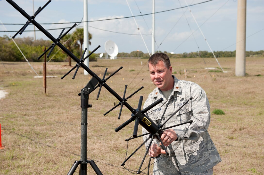 Maj. Larry Skipper, 601st Air and Space Operations Center configuration manager at Tyndall AFB, Fla., adjusts a Joint-Based Expeditionary Connectivity Center antenna at Cape Canaveral AFS, Fla., before the final launch of Space Shuttle Discovery Feb. 24, 2011.  JBECC provides a comprehensive air picture to the entire launch team. (U.S. Air Force Photo by Jonathan Gibson)