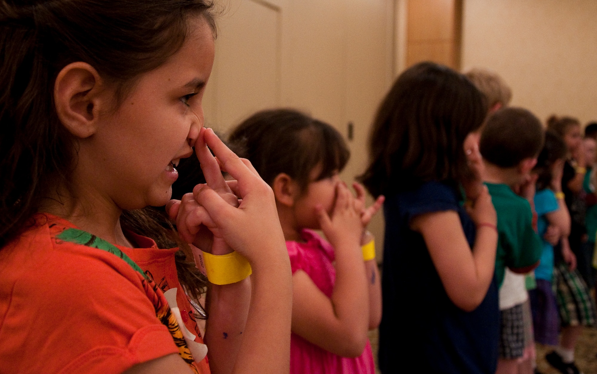Children touch their noses during a game of Simon Says, designed to teach them to lead, follow and listen to directions. This was one of many games that helped them develop communication and problem-solving skills at the western regional Yellow Ribbon Event, May 14-15 at the Tempe Mission Palms Resort in Tempe, Ariz. (U.S. Air Force Photo/Staff Sgt. Erin Smith)