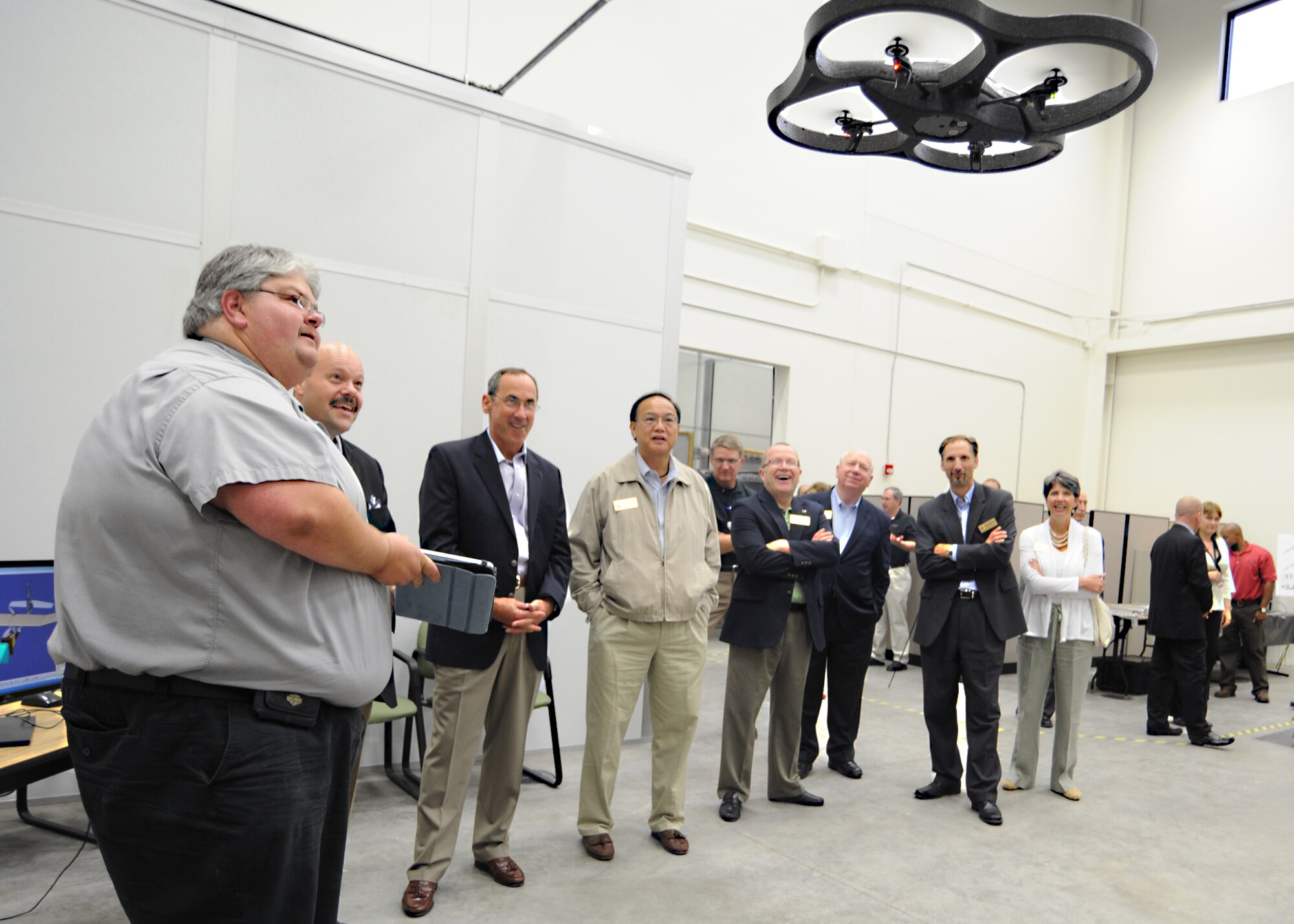 Mr. Brian Brown, National Institute for Aviation Research Computer-Aided Design and Computer-Aided Manufacturing Laboratory associate director, demonstrates a drone to Air Mobility Command commander, General Raymond Johns Jr. and AMC civic leaders May 18, 2011, at Wichita State University, Wichita, Kan. Air Mobility Command civic leaders were given the opportunity to interact with McConnell Airmen and base community partners. The AMC civic leader program assists with bringing Airmen and community leaders face-to-face. (U.S. Air Force photo/Senior Airman Maria A. Ruiz)
