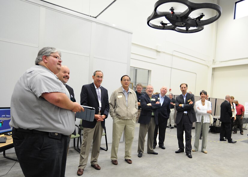 Mr. Brian Brown, National Institute for Aviation Research Computer-Aided Design and Computer-Aided Manufacturing Laboratory associate director, demonstrates a drone to Air Mobility Command commander, General Raymond Johns Jr. and AMC civic leaders May 18, 2011, at Wichita State University, Wichita, Kan. Air Mobility Command civic leaders were given the opportunity to interact with McConnell Airmen and base community partners. The AMC civic leader program assists with bringing Airmen and community leaders face-to-face. (U.S. Air Force photo/Senior Airman Maria A. Ruiz)