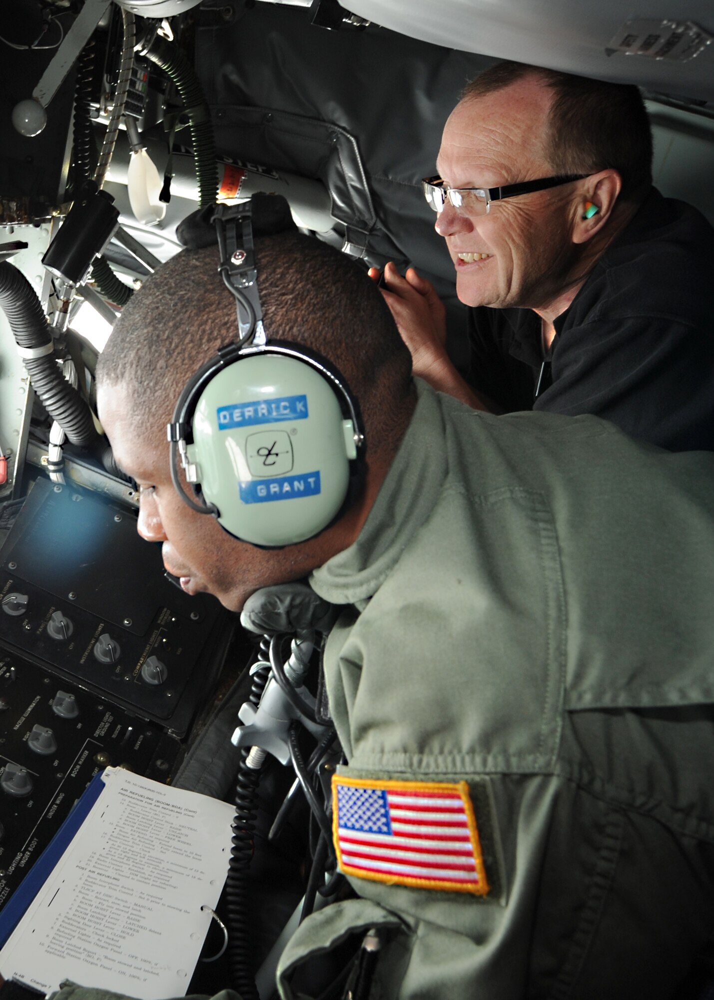 Mr. Don Fisk, Air Mobility Command civic leader from Grand Forks Air Force Base, N.D., views a B-2 Spirit refueling mission next to Master Sgt. Derrick Grant, 344th Air Refueling Squadron boom operator evaluator, May 18, 2011, McConnell Air Force Base, Kan. Air Mobility Command civic leaders were given the opportunity to interact with McConnell Airmen and base community partners. The AMC Civic Leader Conference began in 2008. This gathering assists the command with forming a bond between Airmen throughout AMC and the communities in which they live and work. (U.S. Air Force photo/Senior Airman Maria A. Ruiz)
