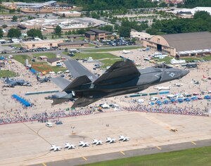 An aircraft carrier variant of the F-35C Joint Strike Fighter flies over Joint Base Andrews, Md., during the 2011 Joint Service Open House. This is the first public appearance of a joint strike fighter aircraft at an air show. Lt. Cmdr. Eric "Magic" Buus piloted the aircraft. The F-35C is a fifth generation strike fighter with stealth capability and has larger wing surfaces and reinforced landing gear for the demanding carrier environment. The aircraft is undergoing test and evaluation at Naval Air Station Patuxent River. (U.S. Navy photo by Andy Wolfe courtesy of Lockheed Martin/Released)