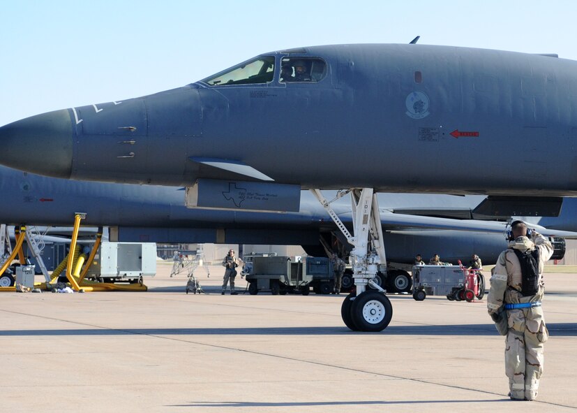 Dyess Air Force Base, Texas--Exercise..Exercise..Exercise Staff Sgt. Eric Huestis, 7th Expeditionary Aircraft Maintenance Squadron, renders a salute before a B-1 takes off at May 16. The 7th Air Expeditionary Wing’s mission is to provide world class Airmen and airpower for the warfighter. (U.S. Air Force photo/ Airman 1st Class Jenifer H. Calhoun)