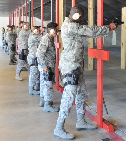 More than 25 Security Forces augmentees fire their weapons during an M-9 qualification training May 18, at Joint Base Charleston - Air Base. Special thanks to all of the men and women who took into account ‘service before self’ by volunteering to become an augmentee during a time of need. (U.S. Air Force photo /Airman 1st Class Jared Trimarchi)
