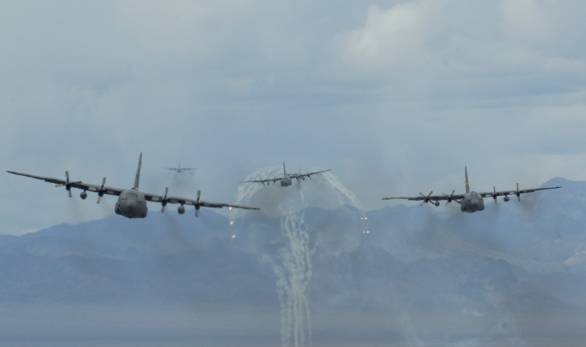 A formation of C-130 Hercules flies May 18, 2011, during an exercise above the Nevada Test and Training Range. (U.S. Air Force photo/Master Sgt. Kevin J. Gruenwald)