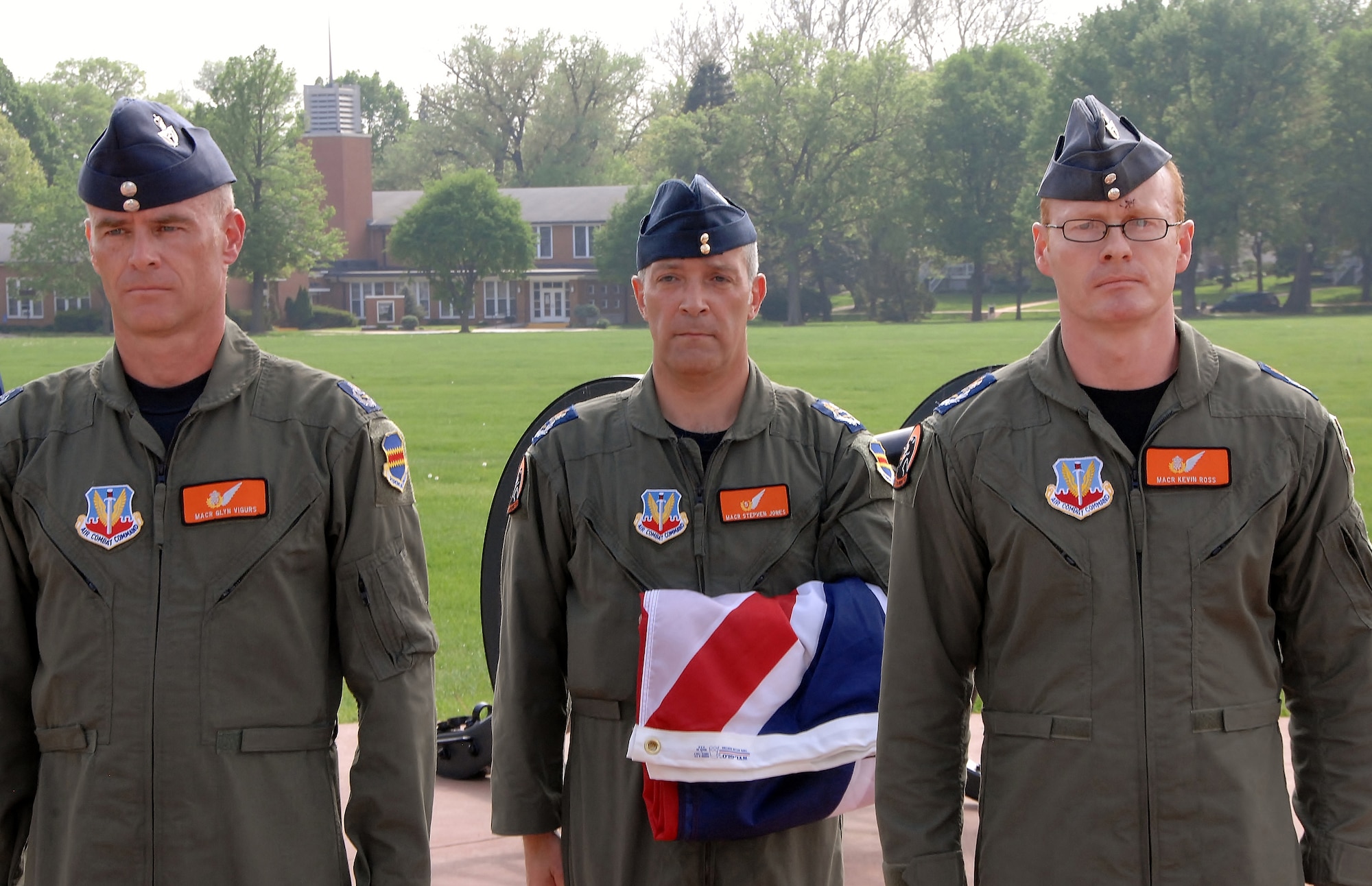 OFFUTT AIR FORCE BASE, Neb. -- Royal Air Force members Master Aircrew Glyn Vigurs, Master Aircrew Stephen Jones and Master Aircrew Kevin Ross stand at attention after lowering the United Kingdom flag during a special retreat ceremony here May 18. The RAF members are attending RC-135V/W initial qualification training here and joined with other members of the 338th Combat Training Squadron in the special ceremony at the parade grounds. (Air Force photo by Dana Heard)