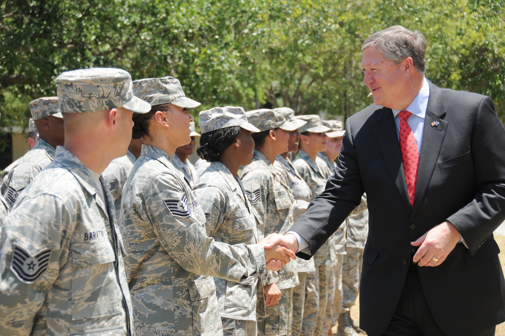 Tech. Sgt. Rosalba Forehand, left, 335th Training Squadron, is congratulated by Secretary of the Air Force Michael Donley as he passes through a cordon of technical sergeants who just found out that they had been selected for promotion to master sergeant.  Secretary Donley and Chief Master Sgt. of the Air Force James Roy visited Keesler May 19.  (U.S. Air Force photo by Kemberly Groue)