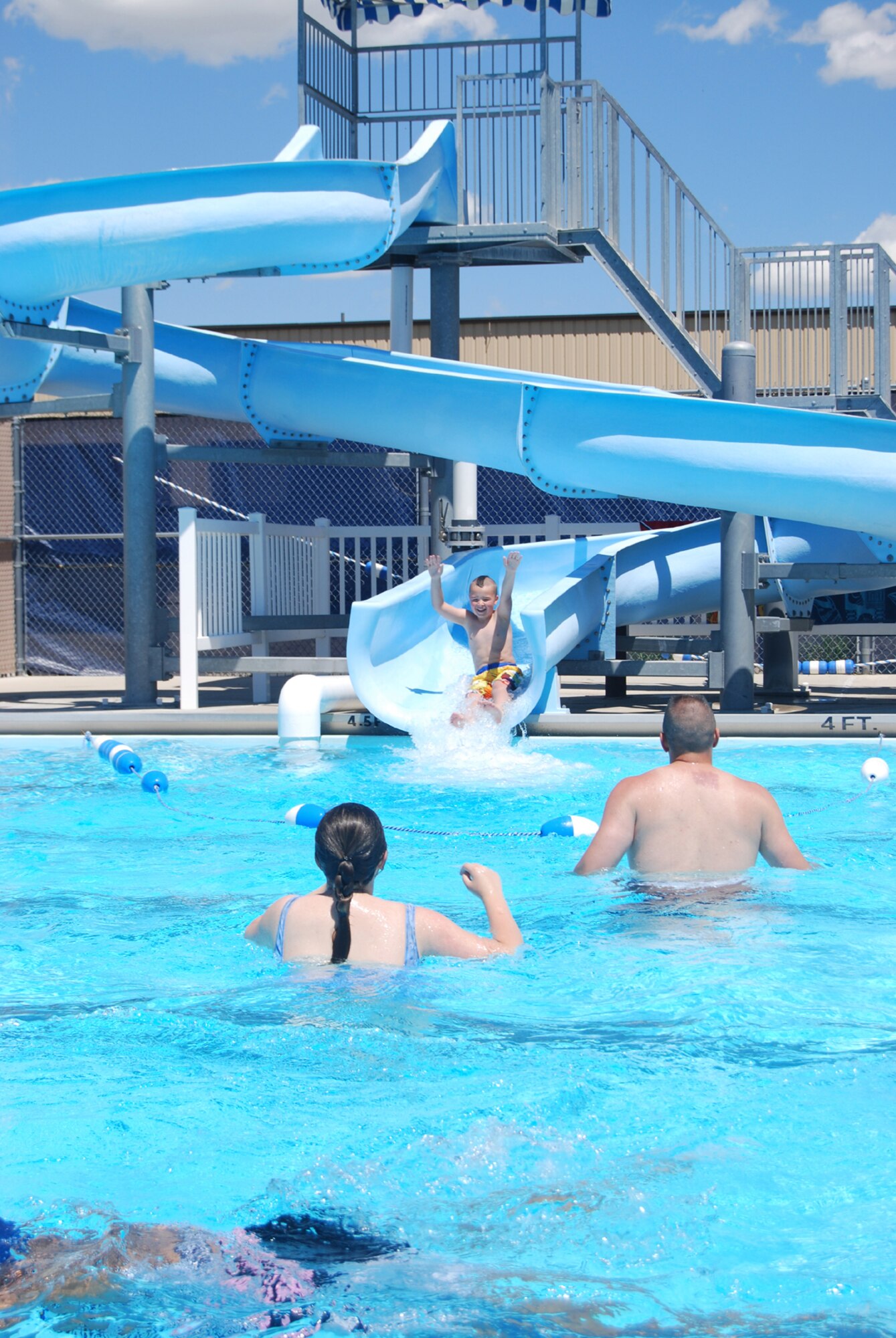 The 90-foot waterslide that drops down into four and a half feet of water is a huge attraction for the Malmstrom base pool. The pool also features two diving boards, a basketball hoop, picnic and children's play area. (U.S. Air Force photo/Senior Airman Kristina Overton)