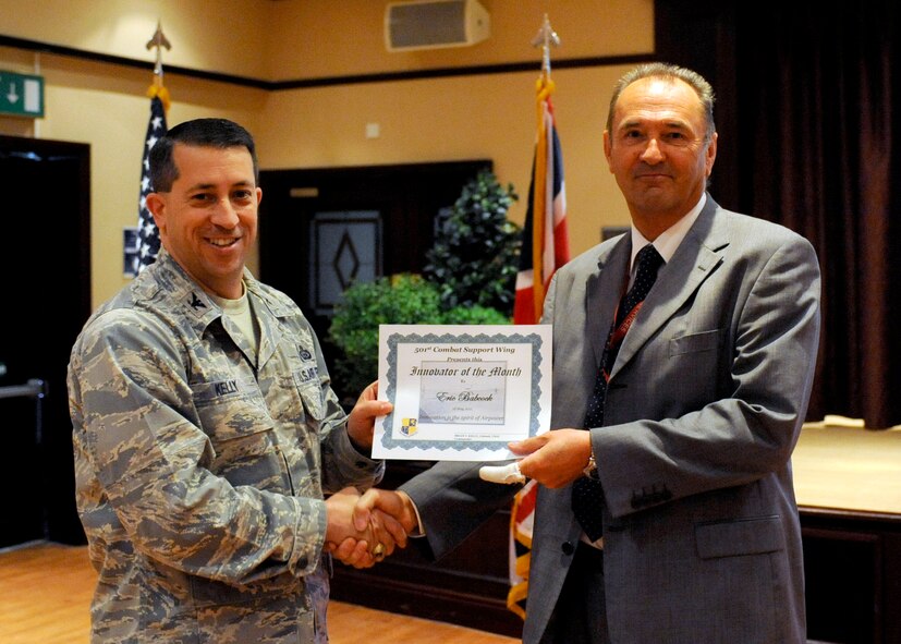 RAF Menwith Hill, United Kingdom - Col. Brian Kelly, 501st Combat Support Wing Commander, presents Innovator of the Month award to Chris Clarke, accepting on behalf of Eric Babcock, May 18, 2011. (U.S. Air Force photo by Staff Sgt. Ave Young) 