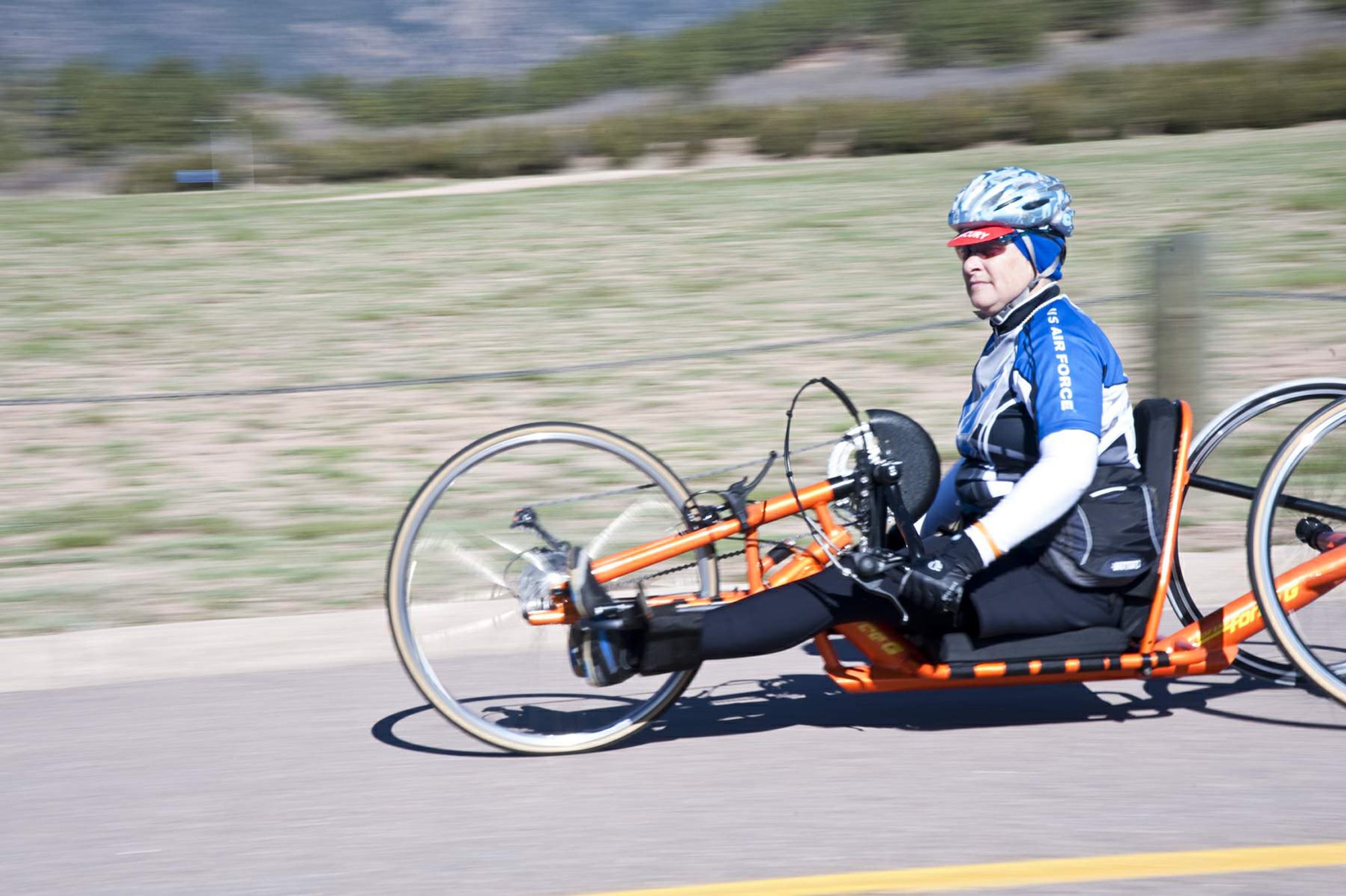 "Jersey" Jeanne Goldy-Sanitate blurs past at the start of the womens handcycle/recumbent/bicycle race at the 2011 Warrior Games May 20,  2011, at the U.S. Air Force Academy in Colorado Springs, Colo. Goldy-Sanitate won bronze with a time of 35:54 over the 10-kilometer course. (U.S. Air Force photo/Staff Sgt. J. Paul Croxon)

