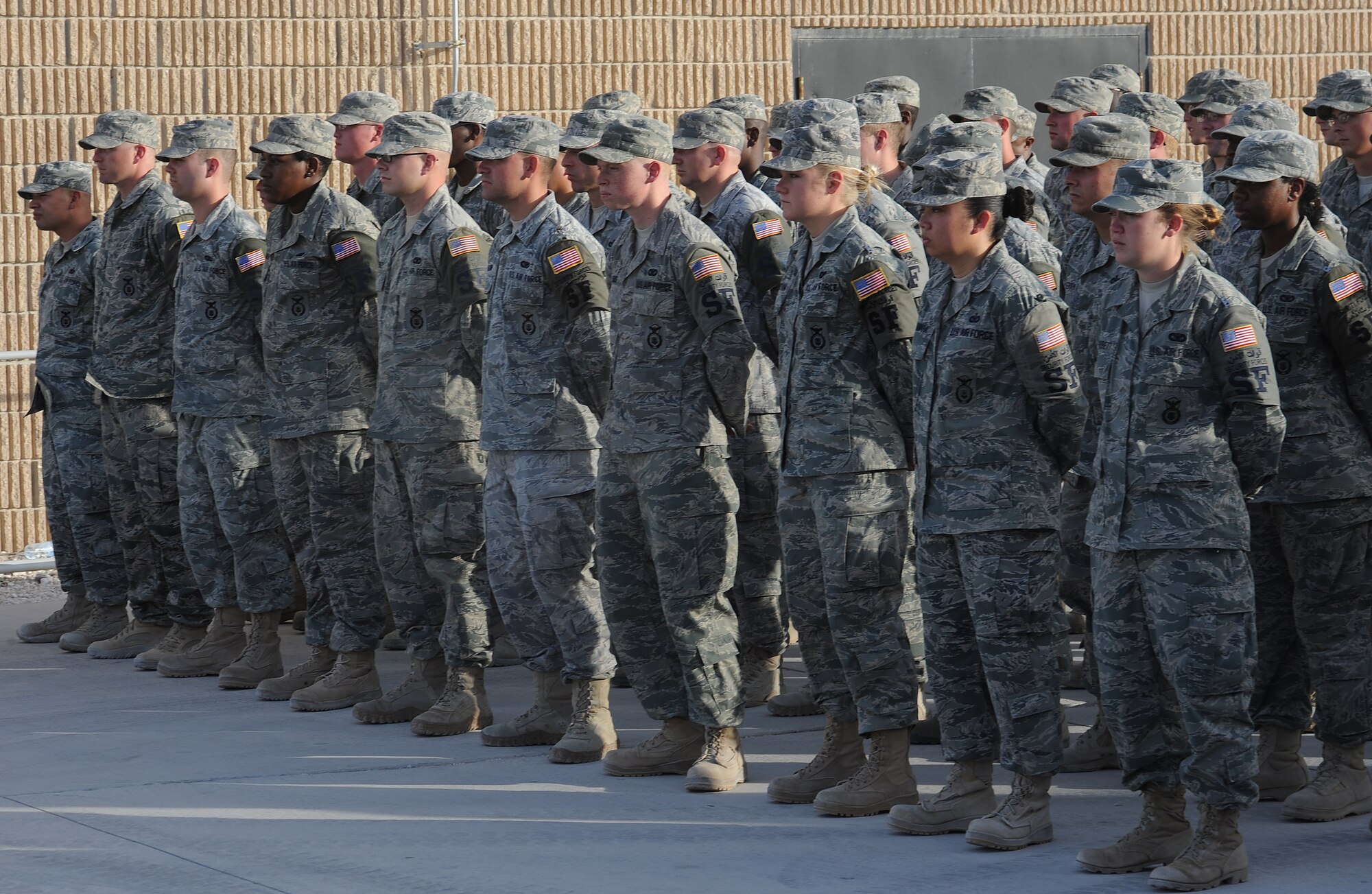 Members from the 379th Expeditionary Security Forces Squadron stand in formation during the police week Retreat Ceremony at an undisclosed location in Southwest Asia, May 21. Police Week honors those who fell defending others and also educates participants on the roles of police and security forces. (U.S. Air Force photo/Staff Sgt. Liliana Moreno)                   