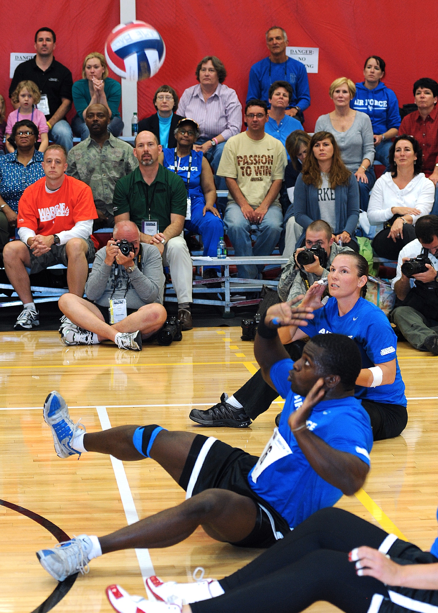 Retired Staff Sgt. Matt Sanders appears to be using "The Force" to slow down the incoming ball as he prepares to return the volleyball during the 2011 Warrior Games. Retired Staff Sgt. Stacy Pearsall shouts encouragement to Sanders as friends, teammates, and family members watch the competition. (U.S. Air Force photo by Duncan Wood)