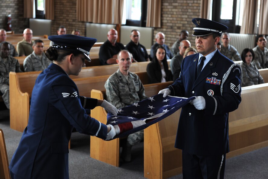 RAF Alconbury, United Kingdom - Base Honor Guard members perform a flag folding ceremony during a memorial honoring fallen security forces members during National Police Week, 20 May 2011.  (U.S. Air Force photo by Tech. Sgt. John Barton)