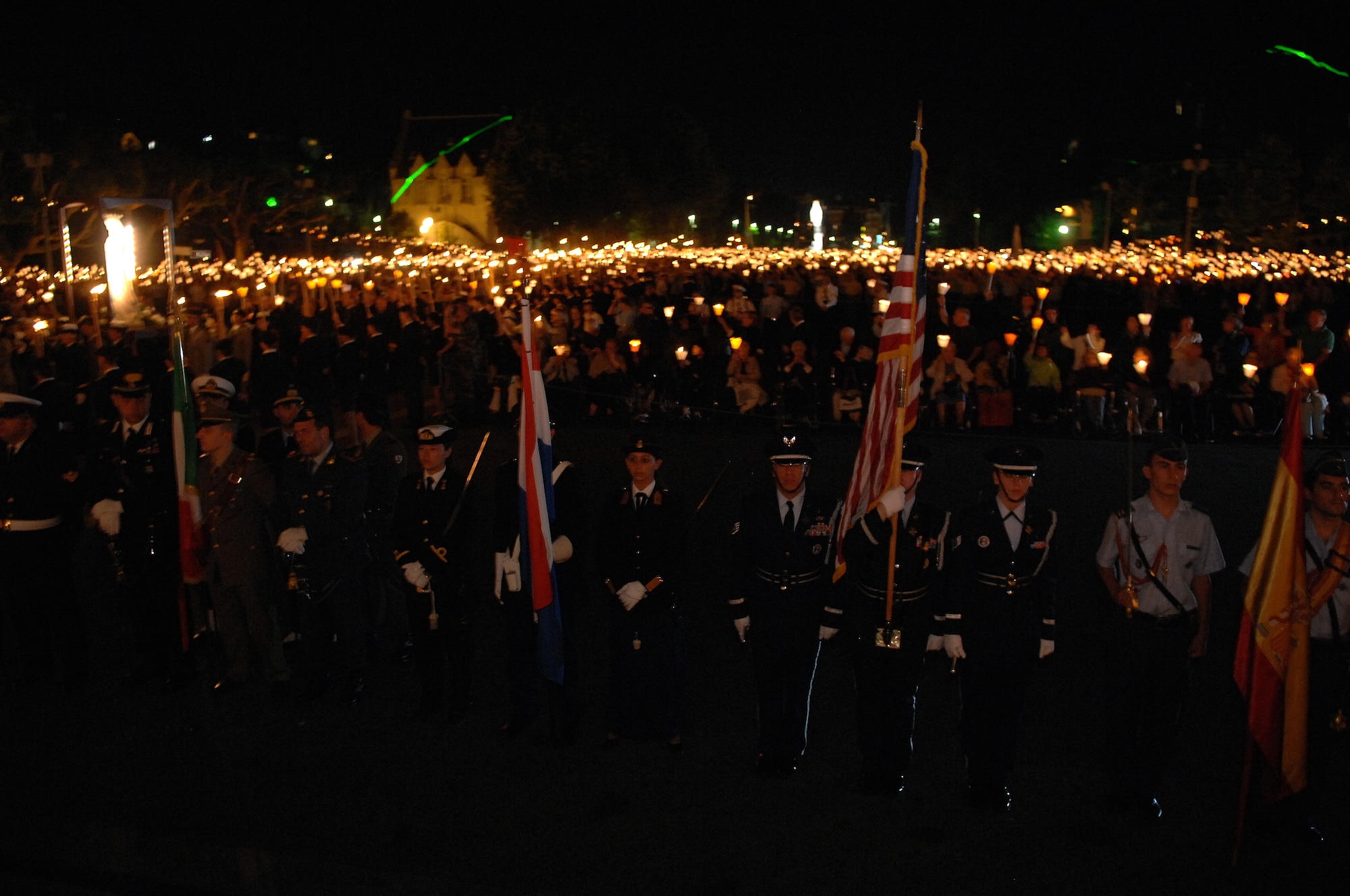 The Honor Guard from Ramstein Air Base stands with thousands of other pilgrims during the Marian Procession that leads to the Rosary Esplanade during the International Military Pilgrimage. The Pilgrimage originated in Lourdes, France, in 1944 when several multi-national military units came together to share a Mass in the Rosary Basilica. This marks the 53rd year of this event that has grown to more than 34 nations participating. (U.S. Air Force photo by Chief Master Sgt. David W. Richards)