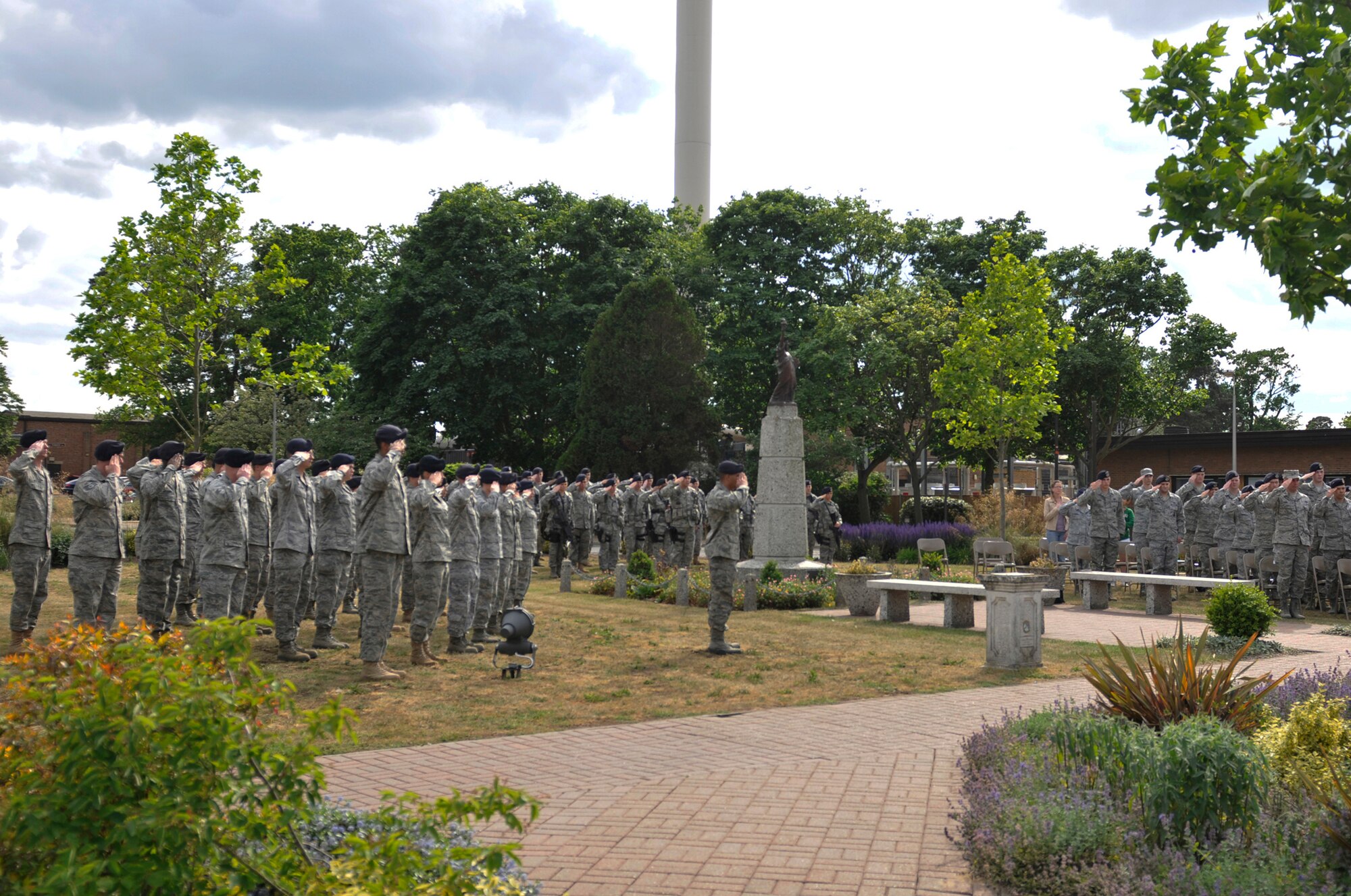 ROYAL AIR FORCE LAKENHEATH, England - Liberty Warriors salute as taps plays during the Memorial and Retreat Ceremony, marking an end to National Police Week at the base flag poles on May 20, 2011. National Police week honors law enforcement officers world-wide for their dedication, sacrifice and service. (U.S. Air Force photo/Senior Airman Tiffany M. Deuel)