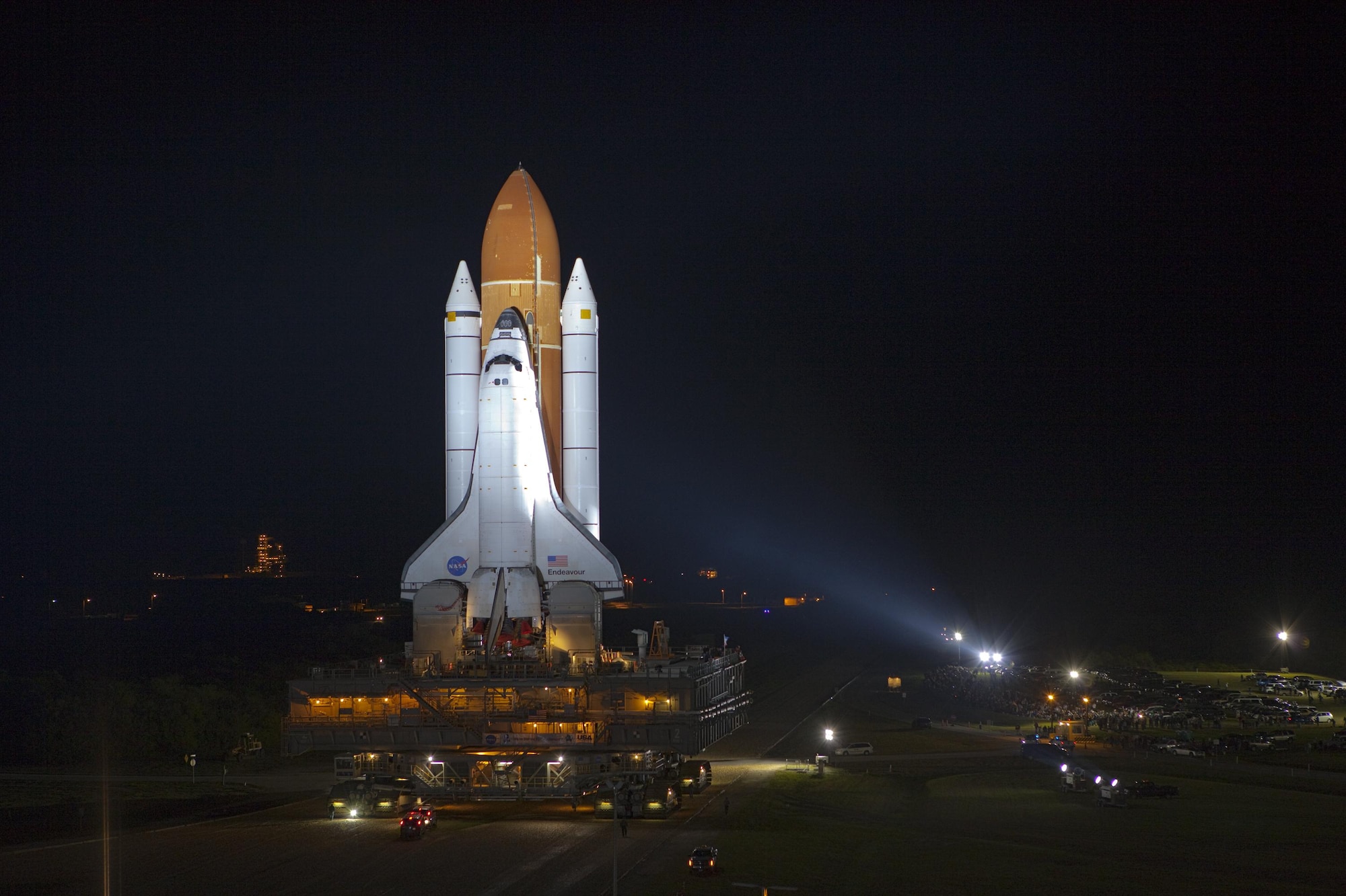 Bathed in xenon lights, space shuttle Endeavour moves along the crawlerway from the vehicle assembly building to Launch Pad 39A at NASA's Kennedy Space Center, Fla., March 11, 2011. Riding atop a crawler-transporter attached to its external fuel tank and solid rocket boosters, Endeavour's last scheduled 3.4-mile trek to the pad, known as "rollout," took just less than eight hours. (NASA courtesy photo) (Released)