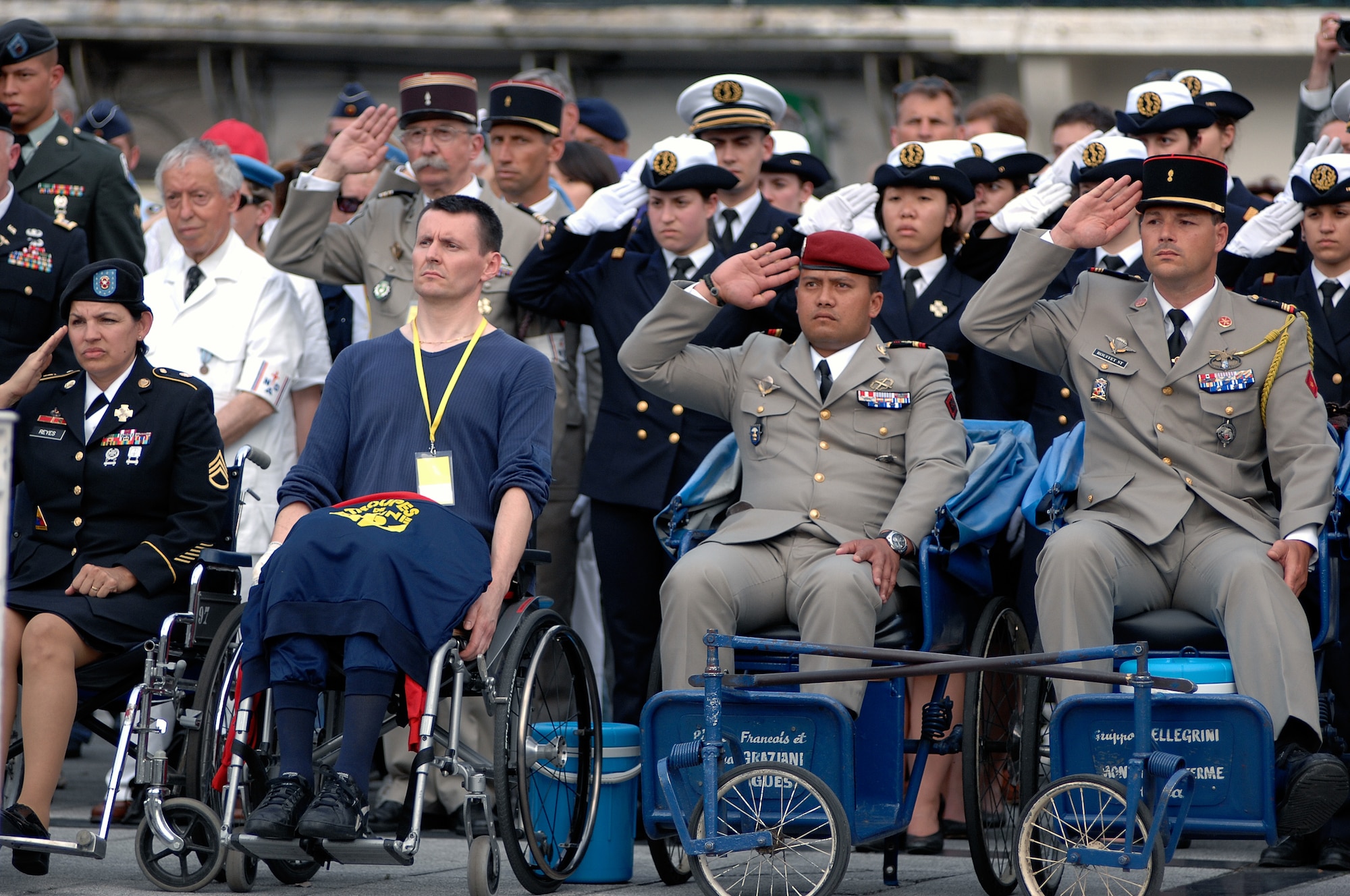 Multi-national wounded warriors pay their respects during the War Memorial ceremony at the Place Peyramale during the International Military Pilgrimage. The Pilgrimage originated in Lourdes, France, in 1944 when several multi-national military units came together to share a Mass in the Rosary Basilica. This marks the 53rd year of this event that has grown to more than 34 nations participating. (U.S. Air Force photo by Chief Master Sgt. David W. Richards)