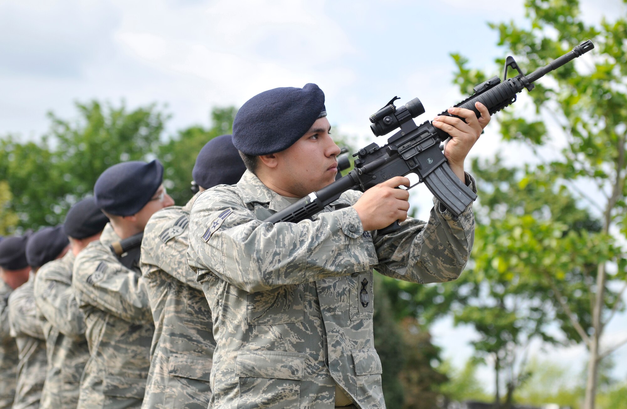 ROYAL AIR FORCE LAKENHEATH, England - Airmen from the 48th Security Forces Squadron perform a 3-volley rifle salute with M4 carbine rifles during the Memorial and Retreat Ceremony at the base flag poles bringing an end to National Police Week on May 20, 2011. National Police week honors law enforcement officers world-wide for their dedication, sacrifice and service. (U.S. Air Force photo/Senior Airman Tiffany M. Deuel)