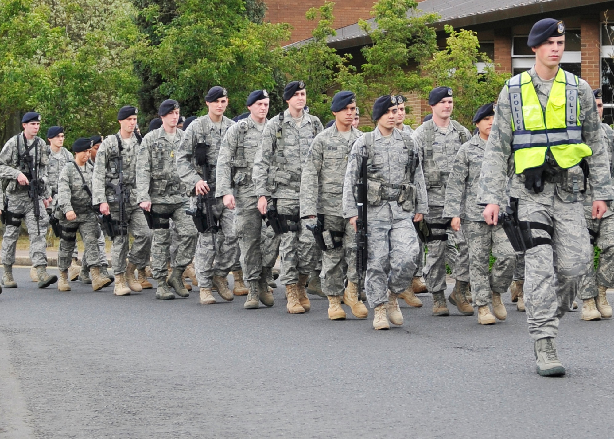 ROYAL AIR FORCE LAKENHEATH, England - Airmen from the 48th Security Forces Squadron march in formation to the base flag poles for a Memorial and Retreat Ceremony that ended National Police Week at the Liberty Wing, May 20, 2011. National Police week honors law enforcement officers world-wide for their dedication, sacrifice and service. (U.S. Air Force photo/Senior Airman Tiffany M. Deuel)