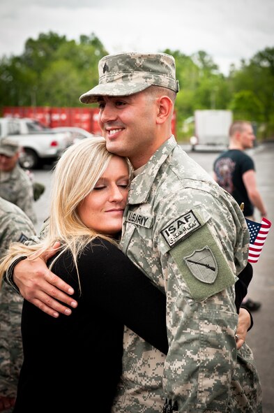 Sgt. Shahid M. Iqbal hugs his fiance, Kara Feese, during a welcome home ceremony held May 1, 2011, at the Kentucky Air National Guard Base in Louisville, Ky., for members of the Kentucky National Guard's Agribusiness Development Team II. Comprised of about 60 Army and Air National Guardsmen, KYADT II just returned from a 12-month deployment to Afghanistan, where they worked to make Afghani farmers become agriculturally self-sufficient, fostered business opportunities through a women's-empowerment initiative and provided force protection. Iqbal and Feese are getting married in July. (U.S. Air Force Photo by Maj. Dale Greer)