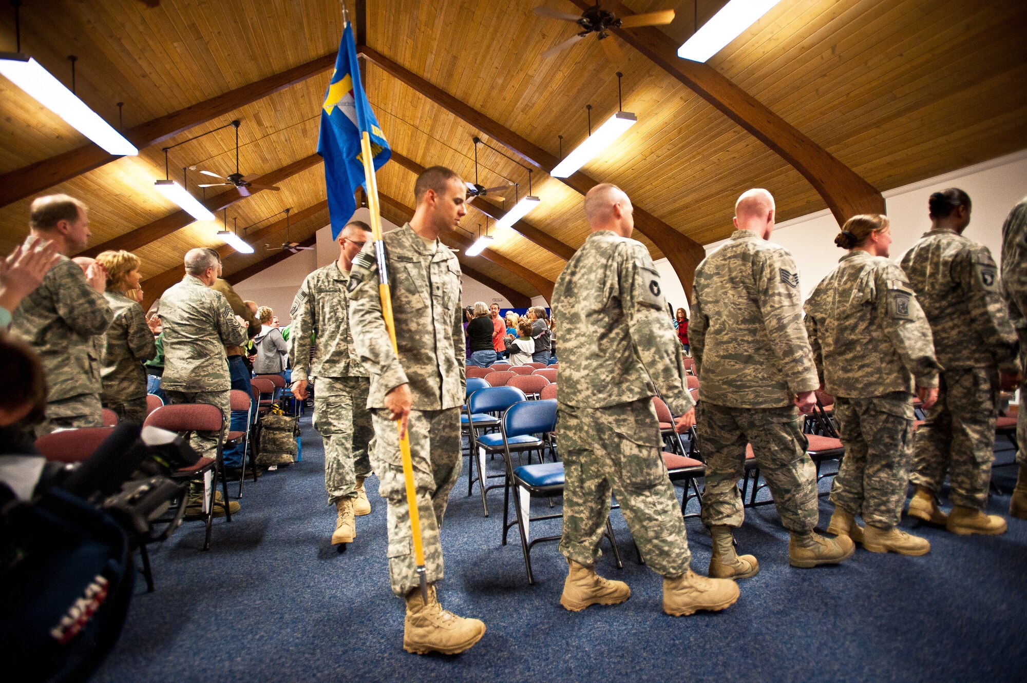 Members of the Kentucky National Guard’s Agribusiness Development Team II receive a standing ovation as they enter the Base Annex at the Kentucky Air National Guard Base in Louisville, Ky., for a welcome home ceremony May 1, 2011. Comprised of about 60 Army and Air National Guardsmen, KYADT II just returned from a 12-month deployment to Afghanistan, where they worked to make Afghani farmers become agriculturally self-sufficient, fostered business opportunities through a women's-empowerment initiative and provided force protection. (U.S. Air Force Photo by Maj. Dale Greer)