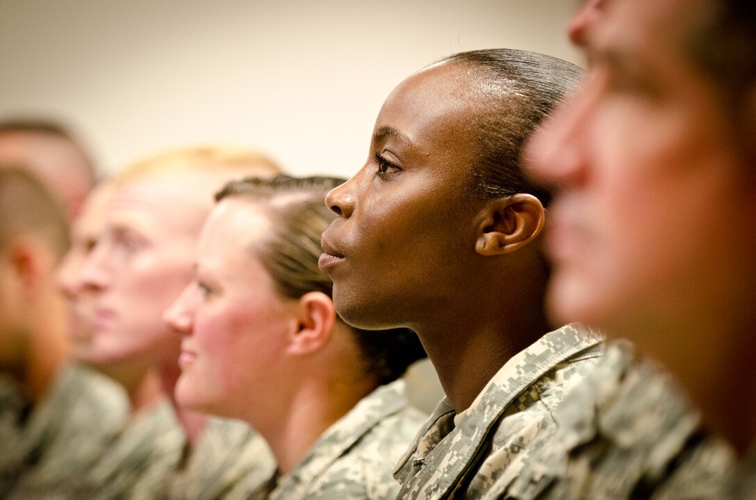 Sgt. Quatrina E. Bilbrew, a human resources specialist with the Kentucky National Guard's Agribusiness Development Team II, listens to Congressman John Yarmuth speak May 1, 2011, during a welcome home ceremony held for the team at the Kentucky Air National Guard Base in Louisville, Ky. Bilbrew was one of more than 60 Kentucky Army and Air Guardsmen who deployed to Afghanistan for 12 months, working to make Afghani farmers become agriculturally self-sufficient, foster business opportunities through a women's-empowerment initiative and provide force protection. (U.S. Air Force Photo by Maj. Dale Greer)