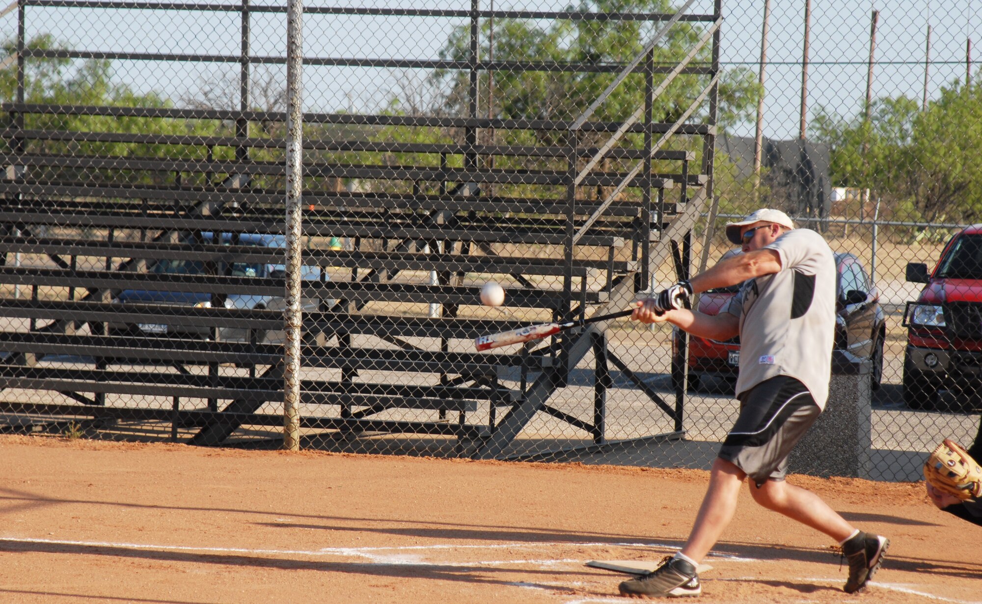 GOODFELLOW AIR FORCE BASE, Texas -- Jeffery Crim, 17th Communications Squadron, sends the ball into far left field during an intramural softball game against the 344th Military Intelligence Battalion May 16. The 344th MIB took home the victory. (U.S. Air Force photo/Airman 1st Class Michael Smith)