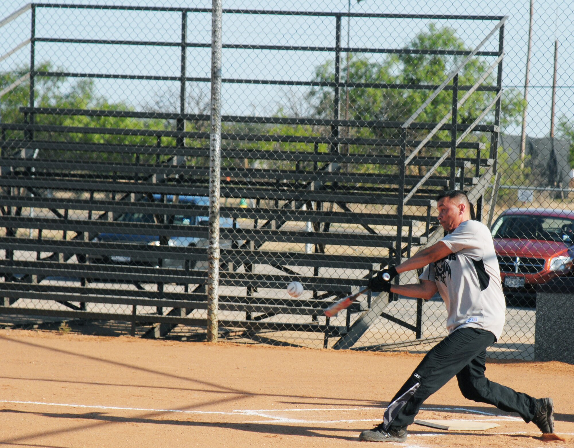 GOODFELLOW AIR FORCE BASE, Texas -- Billy Humphrey, 17th Communications Squadron, knocks one into left field during an intramural softball game against the 344th Military Intelligence Battalion May 16. The 344th MIB took home the victory. (U.S. Air Force photo/Airman 1st Class Michael Smith)