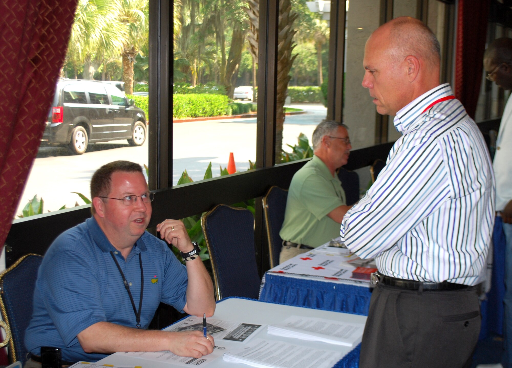 Lt. Col. Tim Fischer, 315 Airlift Wing JAG discusses military benifits with Col. Rick Kemble during the Yellow Ribbon event at Hilton Head Island, S.C. on May 20-22.  (U.S. photo/Capt. Wayne Capps)
