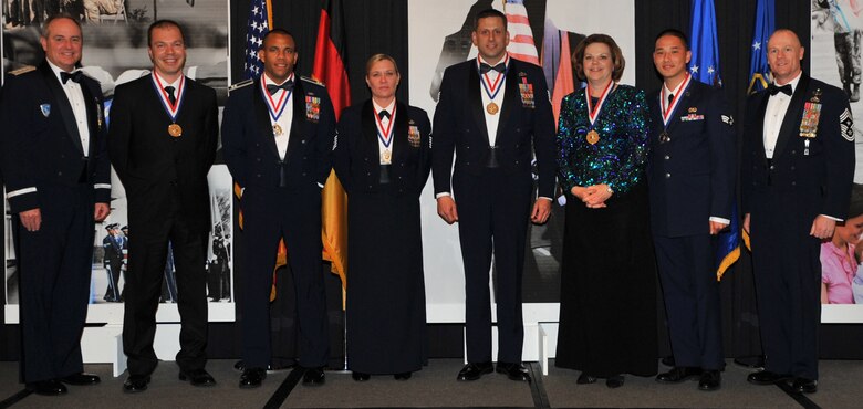 The annual awards winner pose for a photo with Gen. Mark A. Welsh III, U.S. Air Forces in Europe commander (far left), and Chief Master Sgt. Dave Williamson, USAFE command chief master sergeant (far right). The winners pictured are: Eren Ersoy, 39th Air Base Wing, Incirlik Air Base, Turkey; Capt. Gilbert Wyche, Master Sgt. Kathleen Ross and Tech. Sgt. Dustin Goodwin, 48th Fighter Wing, RAF Lakenheath, United Kingdom; and Theresa Vannier, 3rd Air Force and Senior Airman Johnny Nguyen, 86th Airlift Wing, Ramstein Air Base, Germany.  (U.S. Air Force photo by Senior Airman Caleb Pierce/Released)