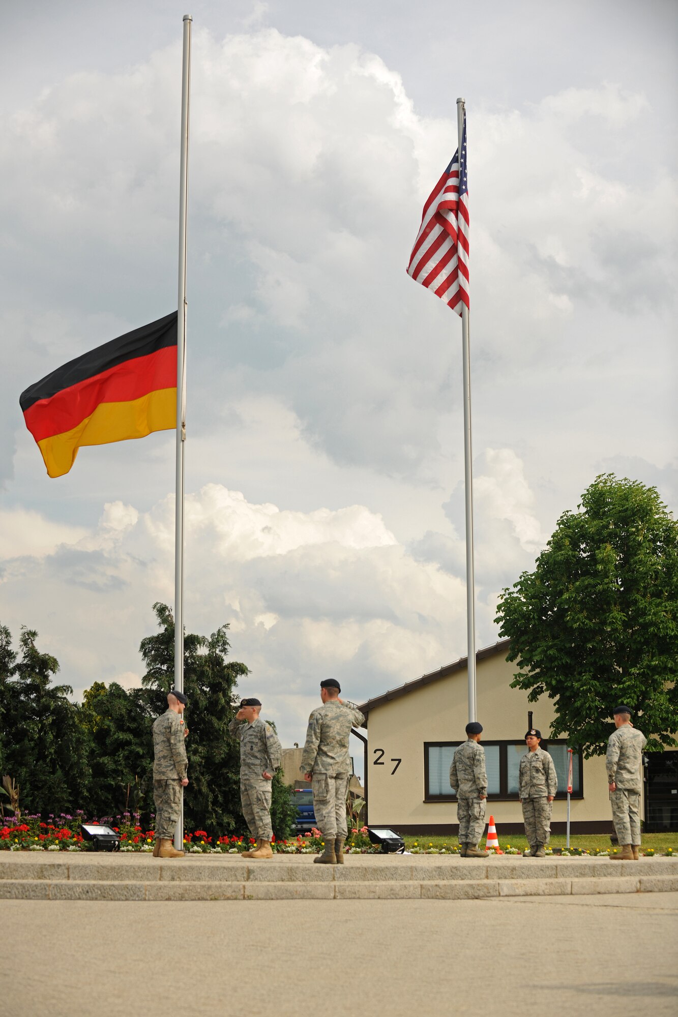 SPANGDAHLEM AIR BASE, Germany – Airmen from the 52nd Security Forces Squadron lower the German flag during a retreat ceremony here May 20. The retreat ceremony coincided with National Police Week, which honors law enforcement members who have lost their lives in the line of duty for the safety and protection of others. (U.S. Air Force photo/Senior Airman Nathanael Callon)